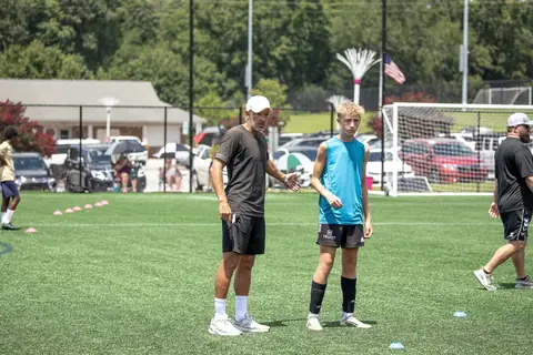 A coach works one-on-one with a young player