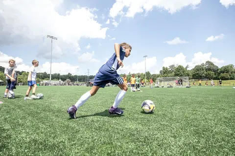A player in blue drives the ball forward