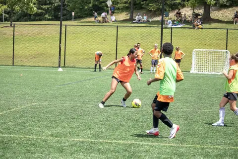 Players in training bibs play a small-sided game