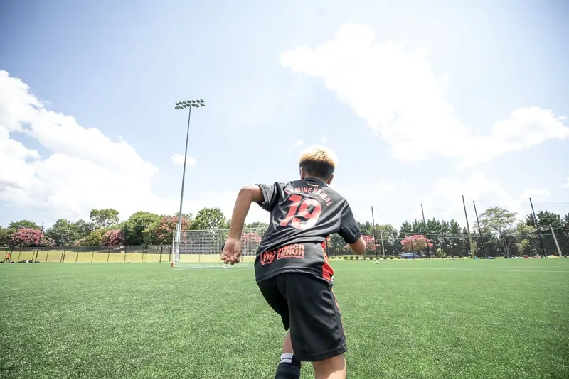 A player sprints toward goal, seen from behind